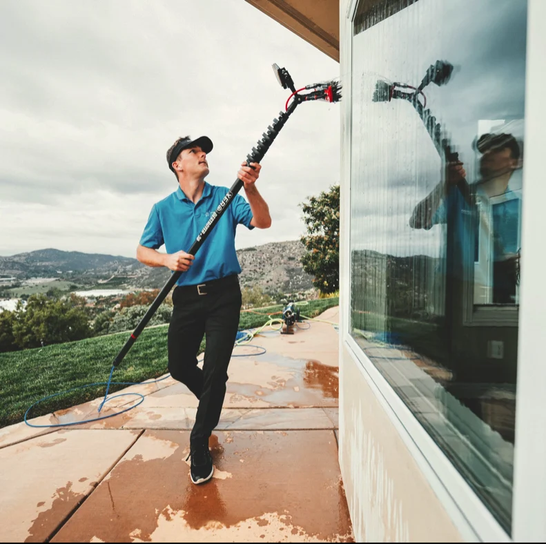 Professional window cleaning with squeegee in North County San Diego