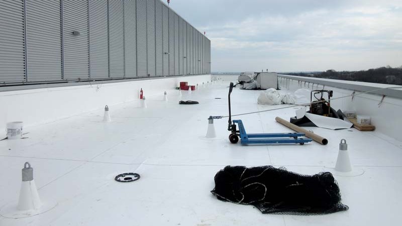 Flat roof membrane being installed
