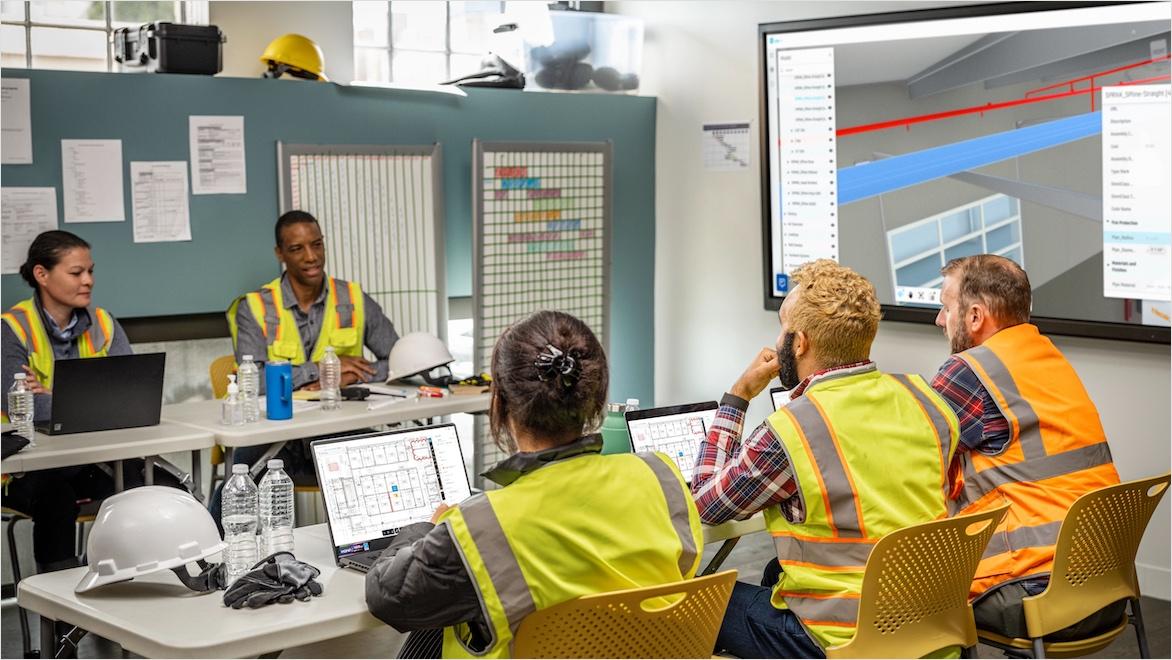 Professional team reviewing project documents at a construction site