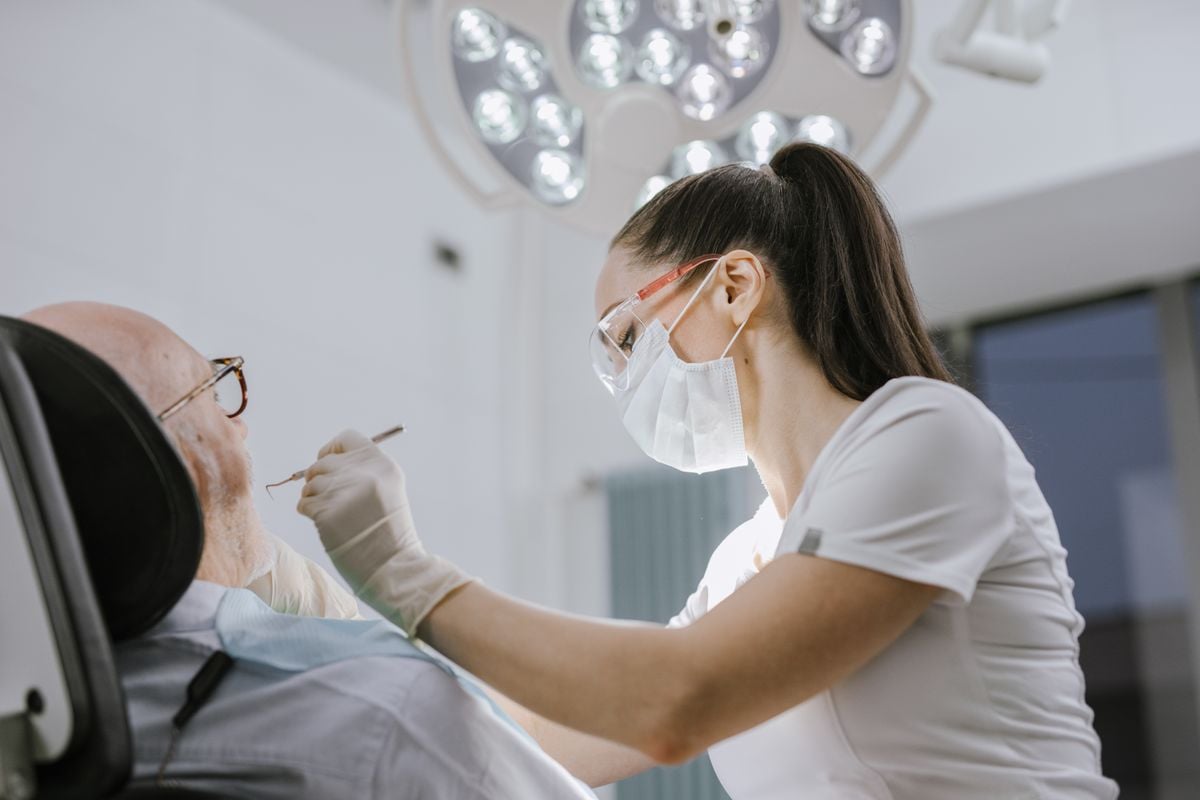 Dental professional providing emergency help for dental trauma assessment