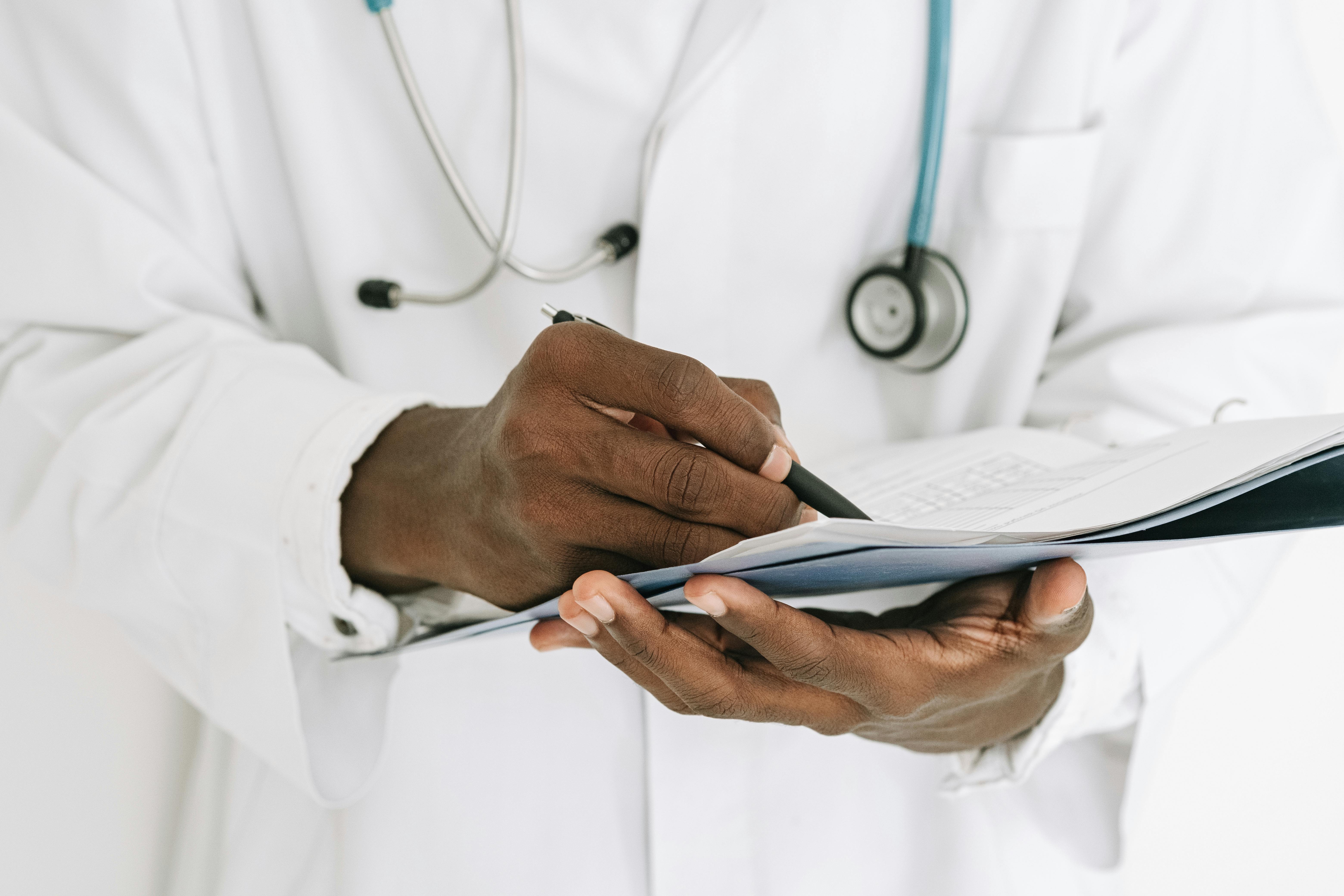 Doctor writing detailed ADHD treatment notes and care plan