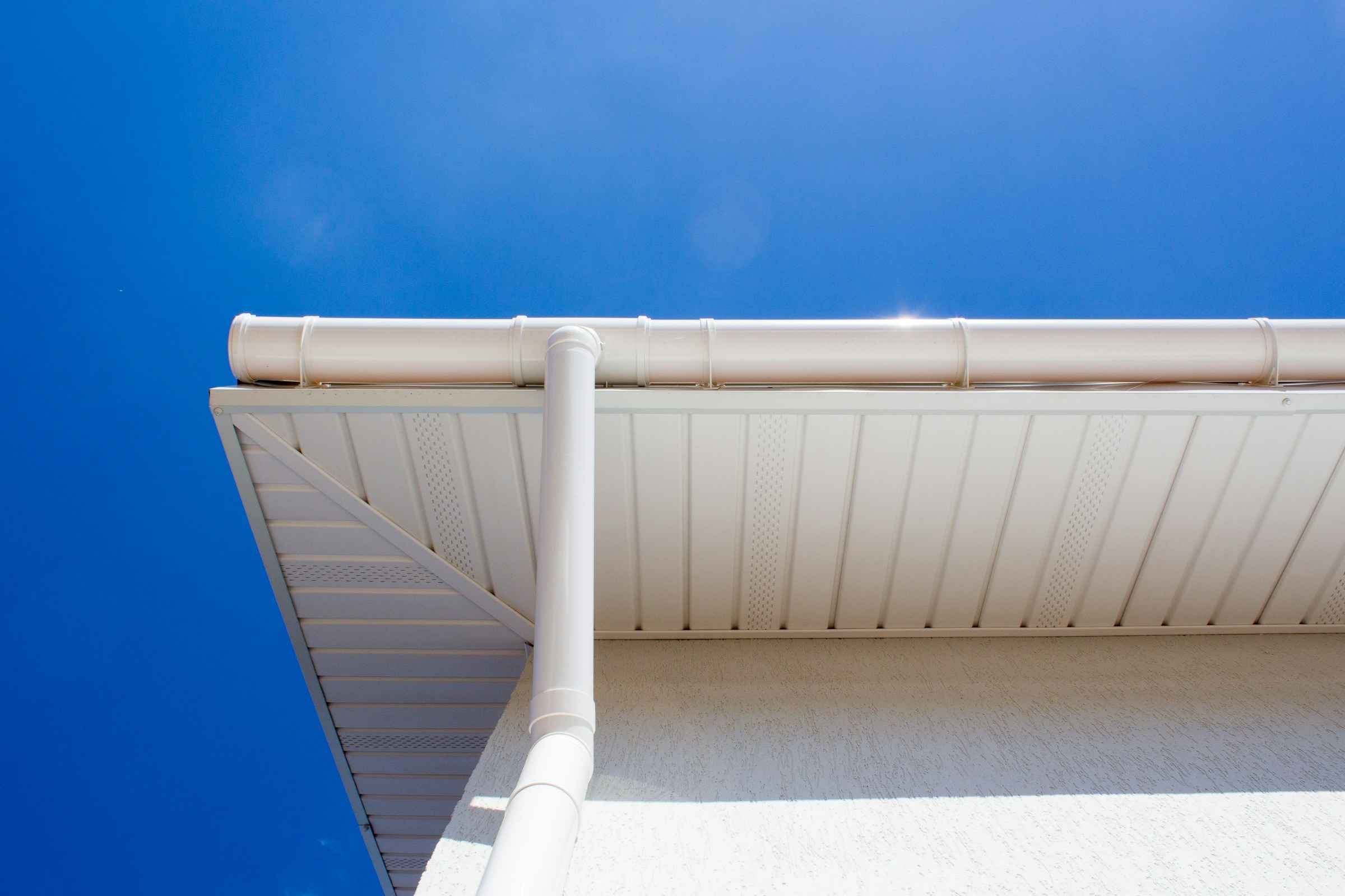 White guttering and downpipe under soffit boards